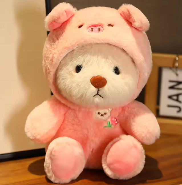 bear in a soft pink pig onesie