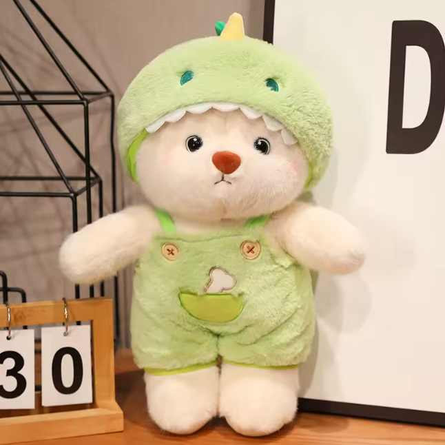 plush bear dressed in a green dinosaur-themed outfit