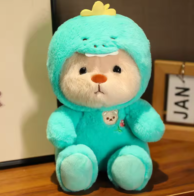 bear in a soft turquoise dinosaur onesie